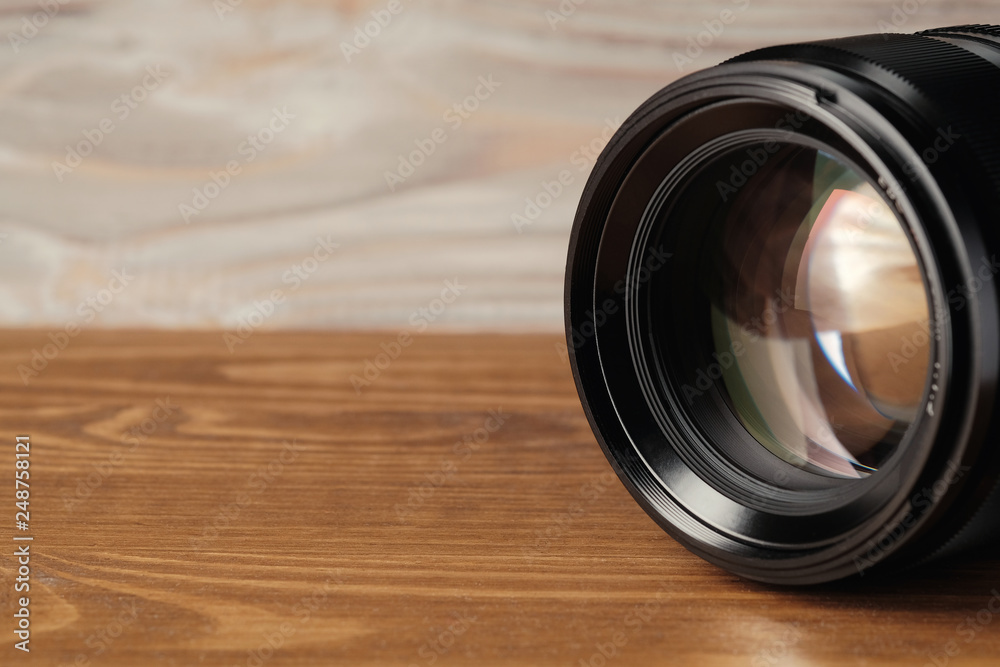 close up photo of camera lens on wood. Lens for camera.