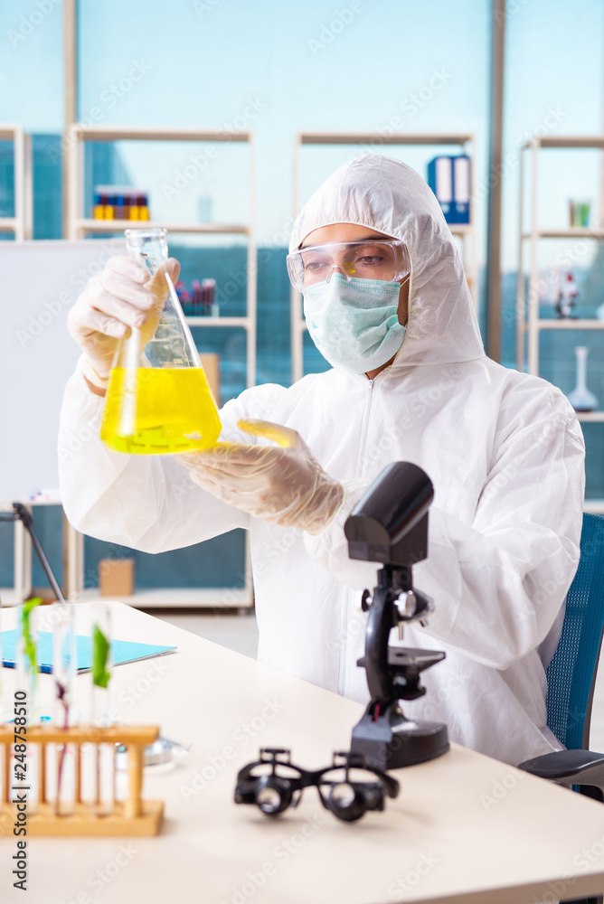 Male biotechnology scientist chemist working in the lab Male biotechnology scientist chemist working in the lab