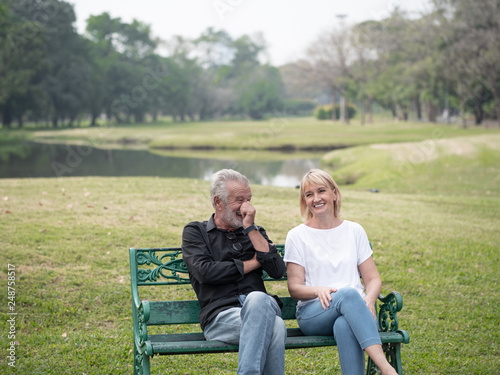 Old couple talk in a park on a sunny day. Happy senior couple relax in the forest spring summer time. free time, lifestyle retirement grandparents concept © xreflex