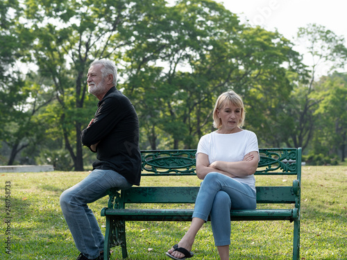 Senior couple having problem, conflict, sadness, do not understand in a park.