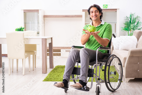 Young handsome man in wheelchair at home © Elnur