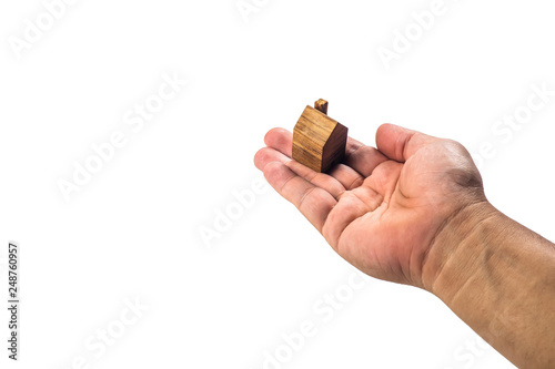 House wood miniature with hand on white background