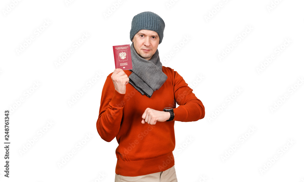 The Caucasian man with the international passport of the Russian Federation in warm clothes. Looks at the watch The Caucasian man with the international passport of the Russian Federation in warm clothes. Looks at the watch