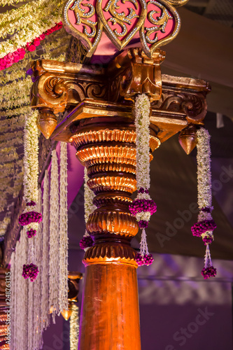 Goregous Jasmine and Rose Floral Garlands Decorate an Intricate Wooden Column at a Wedding in Hyderabad, India photo