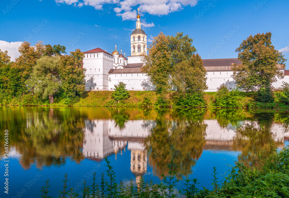 Exterior view and reflection of St. Paphnutius Borovsky Monastery.Kaluga Region.Russia