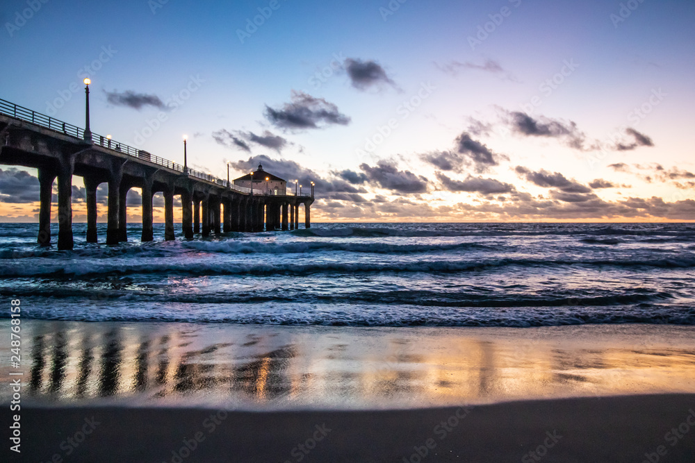 Sunset behind the pier at Manhattan Beach, California