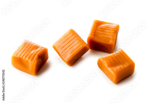 four toffee caramel candies close-up isolated on white background (with clipping path)