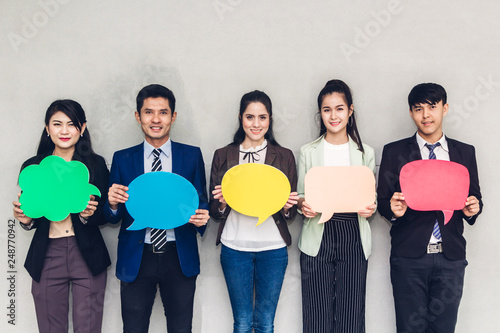 Group of business people holding a speech bubble icon
