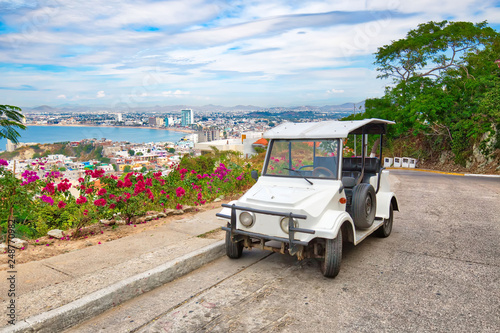 Pulmonia taxi with panoramic view of the Mazatlan Old City in the background, Mexico