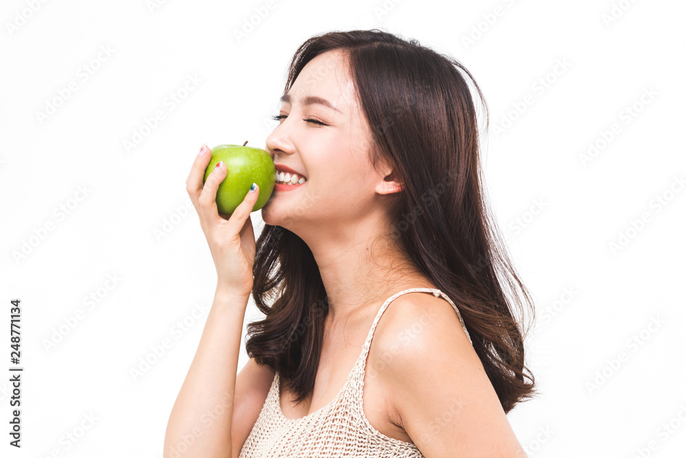 Woman holding and eating fresh green apple on white background.dieting concept.healthy lifestyle Woman holding and eating fresh green apple on white background.dieting concept.healthy lifestyle