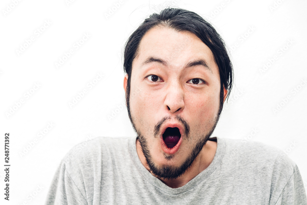 Portrait of happy smiling asian young handsome man looking at camera and surprised face expression cheering on white background Portrait of happy smiling asian young handsome man looking at camera and surprised face expression cheering on white background