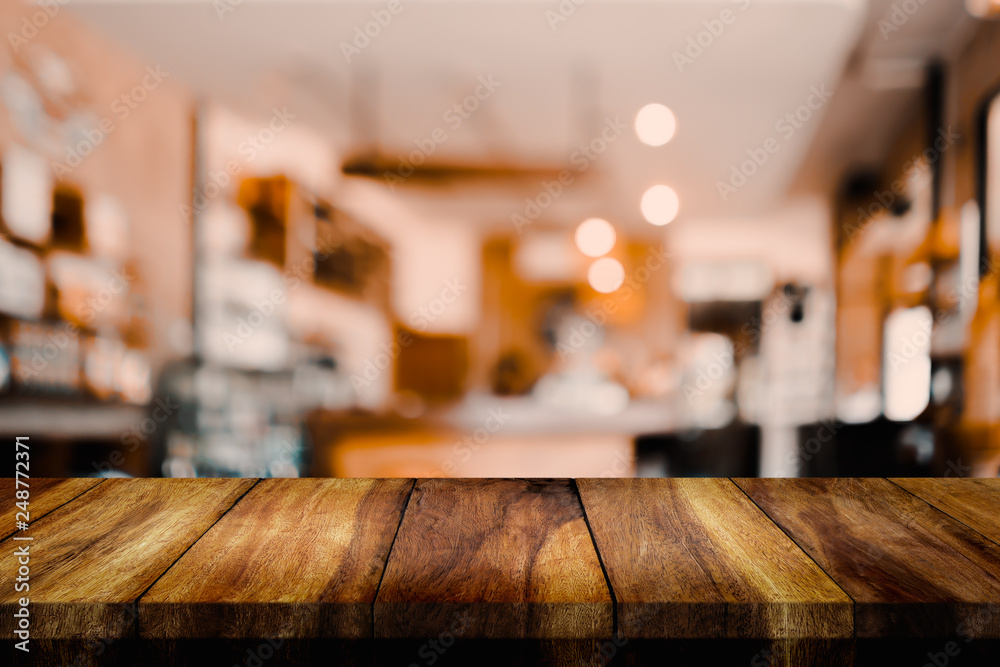 Empty wood table with blur interior coffee shop or cafe for background.
