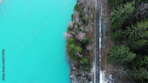 A slow slide over a mountain railways near an iced river. Shot with Dji drone photo