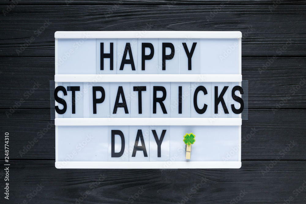 Lightbox with title Happy st Patrick Day and photobooth bow tie beard on wooden sticks on black wooden background. Creative background to St. Patricks Day Lightbox with title Happy st Patrick Day and photobooth bow tie beard on wooden sticks on black wooden background. Creative background to St. Patricks Day