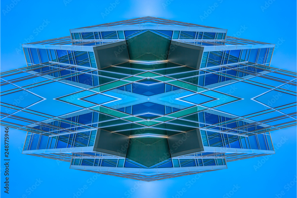 Fototapeta premium Angular building looking abstract with sky reflect