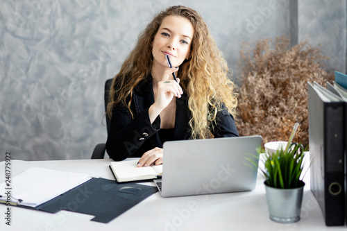 beautiful smiling women.business woman chatting with coworker.business woman sitting at her desk in office.