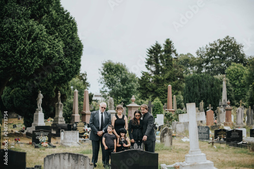 Family giving their last goodbyes at the cemetery