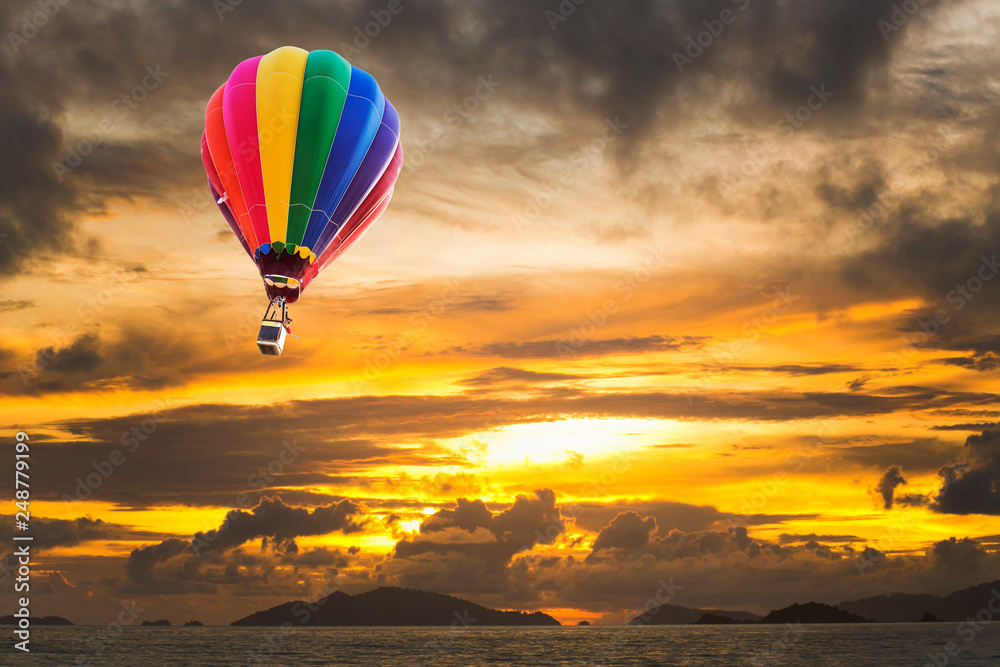 Hot air balloons over the ocean at sunset with dramatic sky. Honolulu Hawaii