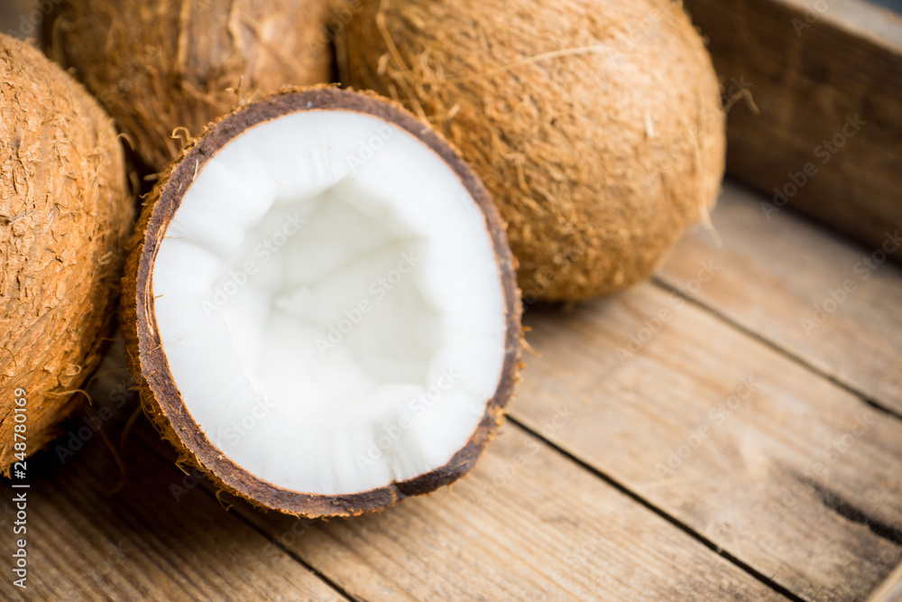 Fresh coconuts on the rustic background. Selective focus. Shallow depth of field. Fresh coconuts on the rustic background. Selective focus. Shallow depth of field.