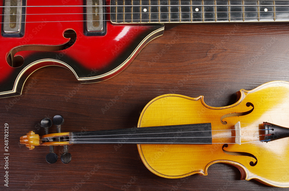 Violin and bass guitar on the table Violin and bass guitar on the table