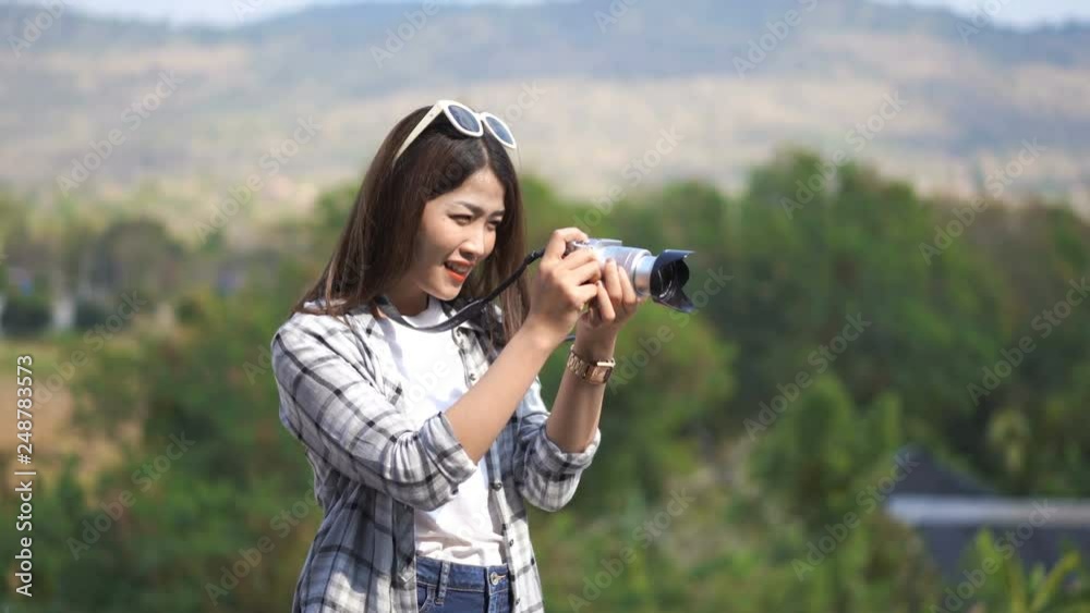 tourist woman taking a photo with her camera in nature tourist woman taking a photo with her camera in nature