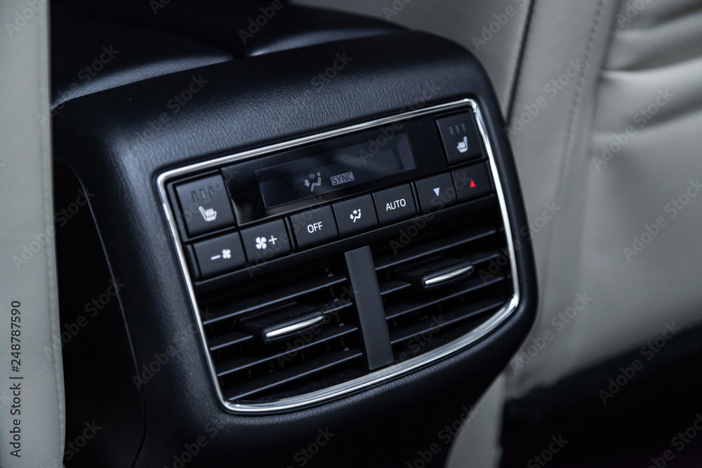 Сlose-up of the car  black interior:  seat heating buttons, adjustment of the blower, air conditioner and other buttons.