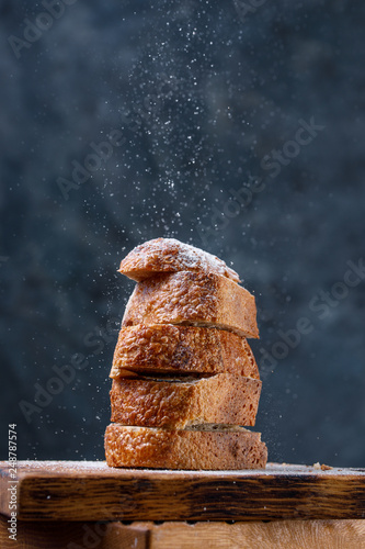Fresh craft bread sliced on decorative boards with flour sprinkled on top.The concept of healthy food and traditional bakery.