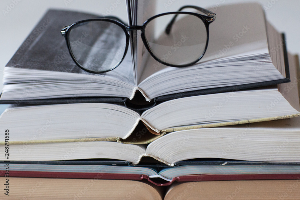 Stack of books and glasses on white background. Morning. Study. Education. Stack of books and glasses on white background. Morning. Study. Education.