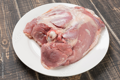 fresh turkey meat on the bone, lying on a plate