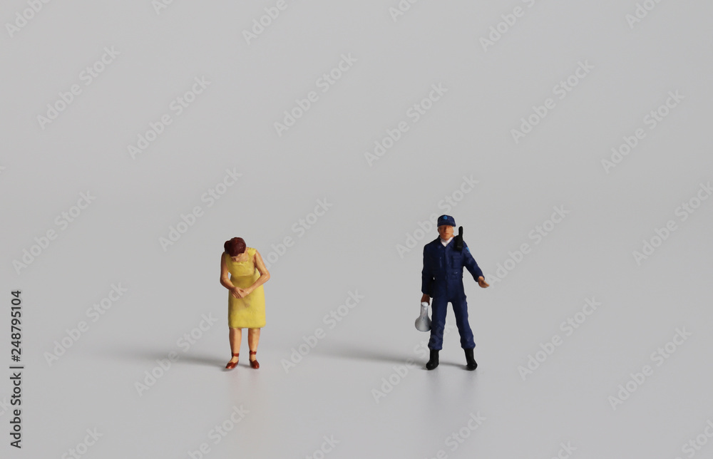 Miniature man police standing side by side with a miniature woman. Miniature man police standing side by side with a miniature woman.
