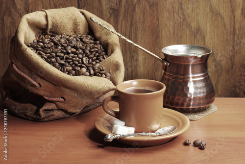 Coffee set. A cup of coffee, coffee grinder, coffee Turk, coffee beans, a bag of coffee beans