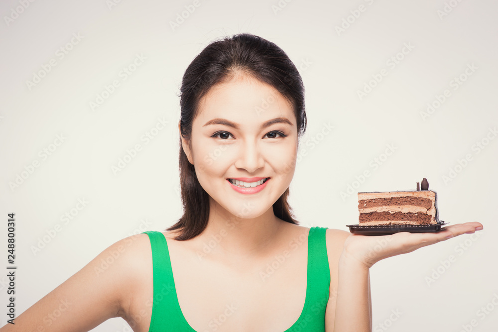 Beautiful smiling asian young woman with a chocolate cake isolated on white background.