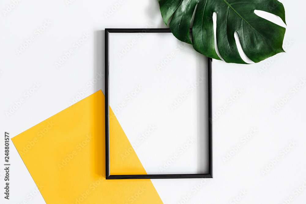 Summer composition. Tropical palm leaves, yellow paper blank, photo frame on pastel gray background. Summer concept. Flat lay, top view, copy space - obrazy, fototapety, plakaty 