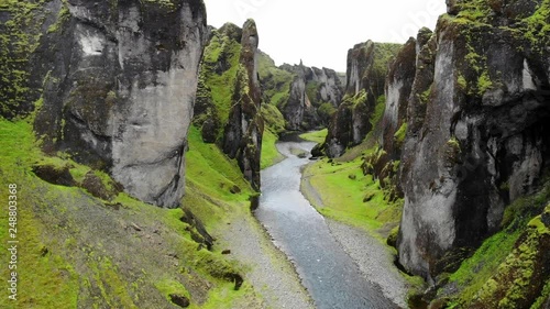 Flying through the Fja√∞r√°rglj√∫fur Canyon (AKA Justin Bieber Canyon) in Iceland with towering rock walls and the Fja√∞r√° river winding below photo