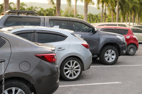 Closeup of back or rear side of brown car and other cars parking in parking area with natural background.  © Amphon