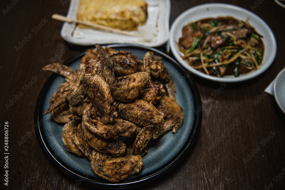 Fried chicken wing and Fried chicken drumstick with black pepper in Japanese style served with Omelette and stir fried pork liver with Chinese chives. Fried chicken wing and Fried chicken drumstick with black pepper in Japanese style served with Omelette and stir fried pork liver with Chinese chives.