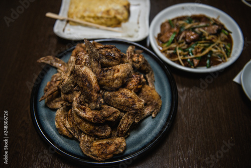 Fried chicken wing and Fried chicken drumstick with black pepper in Japanese style served with Omelette and stir fried pork liver with Chinese chives.