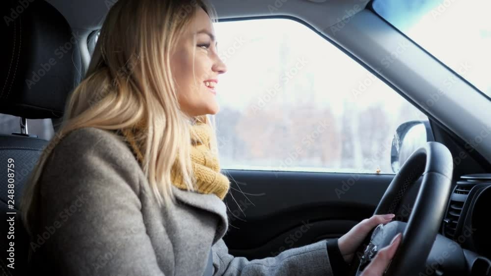 driver sing and dance to music in moving car in city. driver sing and dance to music in moving car in city.