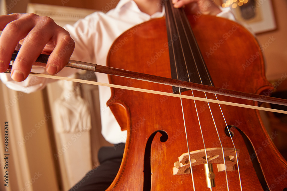 One cellist performing a cello piece One cellist performing a cello piece