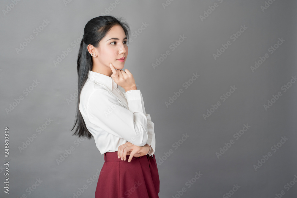 Portrait of beautiful business woman on grey background, studio shot Portrait of beautiful business woman on grey background, studio shot