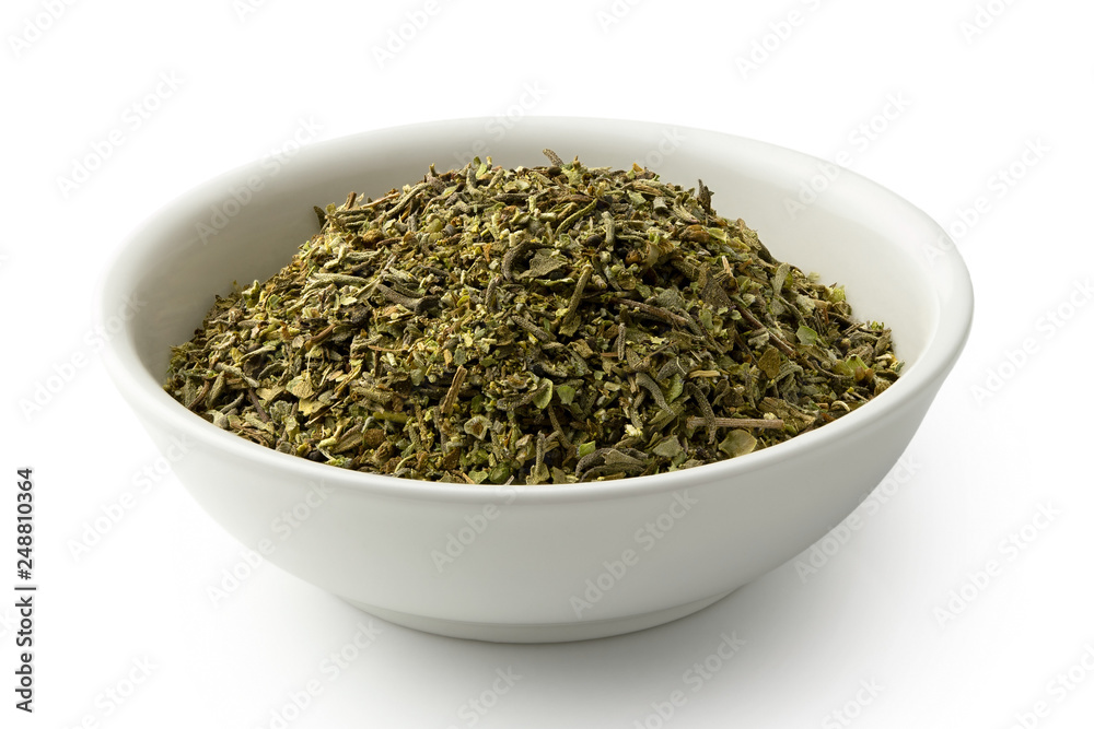 Dried chopped provence herbs in a white ceramic bowl isolated on white. Dried chopped provence herbs in a white ceramic bowl isolated on white.