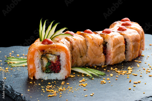 Slika na platnu Sushi roll red Dragon on black background