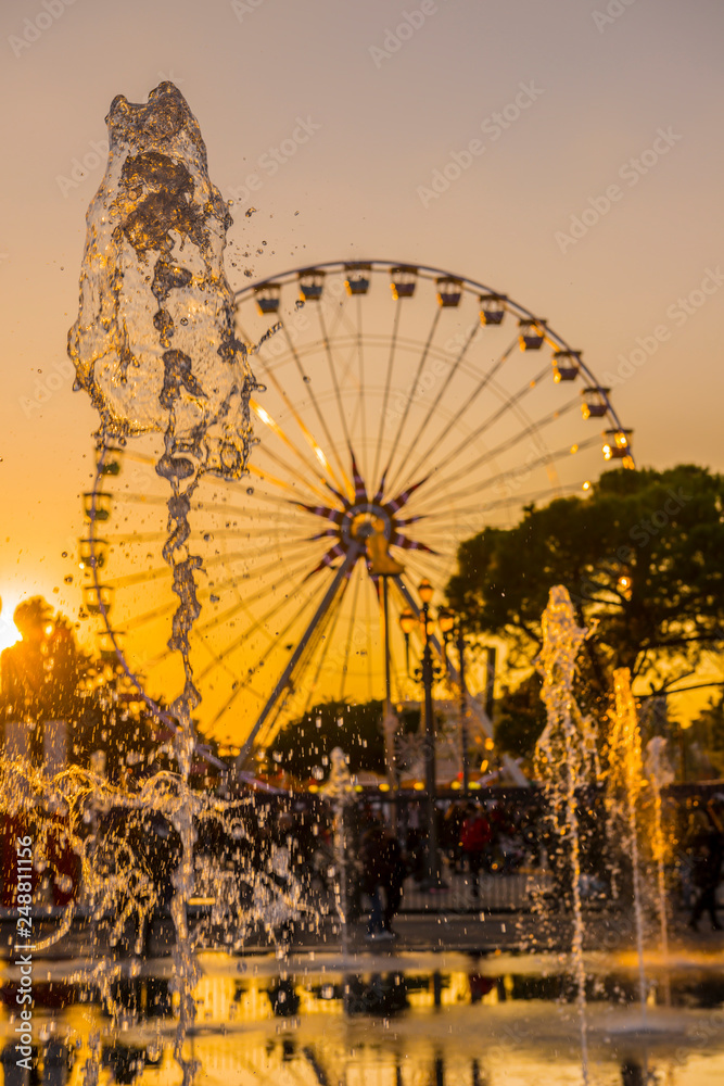 custom made wallpaper toronto digitalWater Fountain and Ferris Wheel in Sunset in Nice in Provence-Alpes-Côte d'Azur, France.