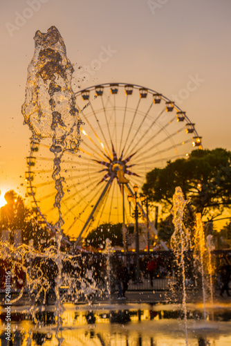 Wallpaper Mural Water Fountain and Ferris Wheel in Sunset in Nice in Provence-Alpes-Côte d'Azur, France. Torontodigital.ca