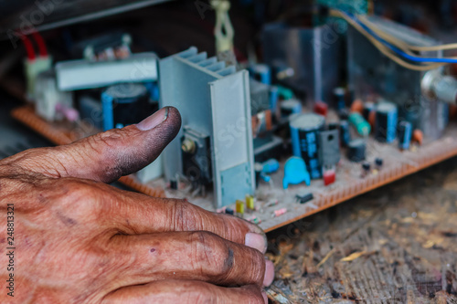 Electrician repairing a TV in old television repair shop