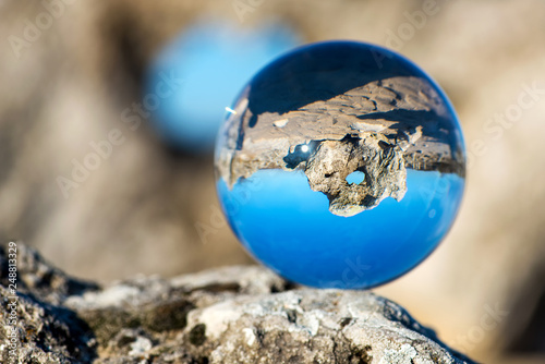 Upside down landscape of Pobiti Kamani, The Stone Forest Natural Reserve near Varna in Bulgaria, Eastern Europe - reflection in a lens ball - selective focus, space for text