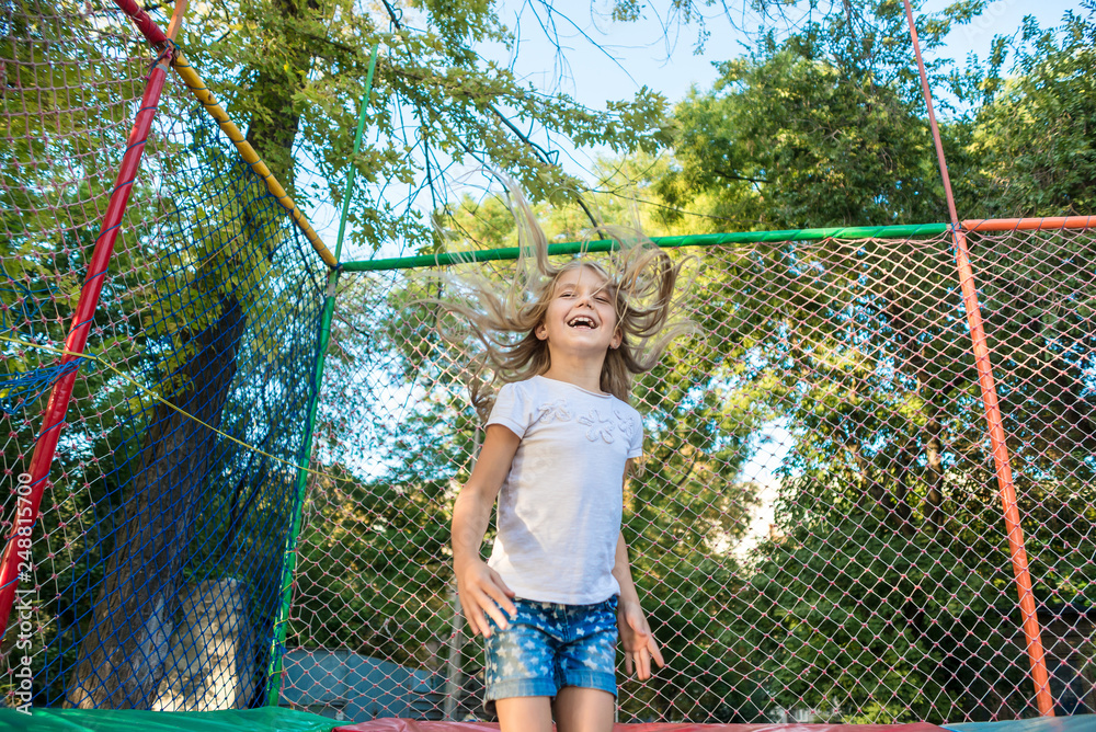 Happy funny girl jumping on trampoline Happy funny girl jumping on trampoline