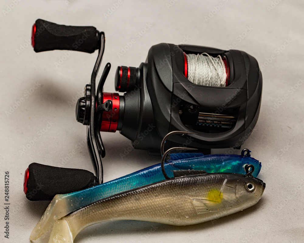 Close up of baitcasting reel with two rubber bass lures Stock Photo