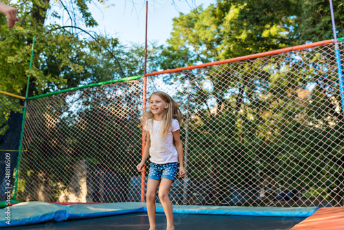 Happy funny girl jumping on trampoline © illustrissima