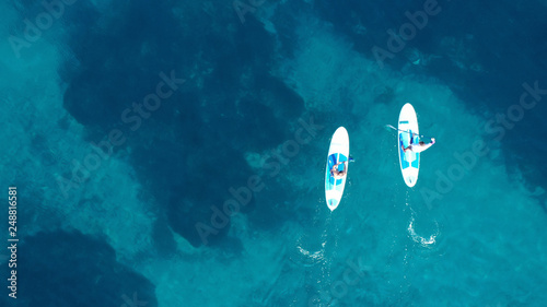 Εκτύπωση καμβά Aerial drone bird's eye view of 2 men exercising sup board in turquoise tropical